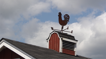 A chicken weather vane with impending bad weather